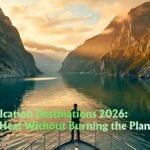 Coolcation destinations 2026 – misty fjord at sunrise with electric ferry and lush green cliffs