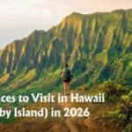 Hiker looking out over the Na Pali coast from a high vantage point, one of the Best Places to Visit in Hawaii