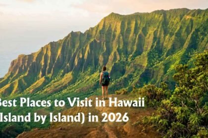 Hiker looking out over the Na Pali coast from a high vantage point, one of the Best Places to Visit in Hawaii