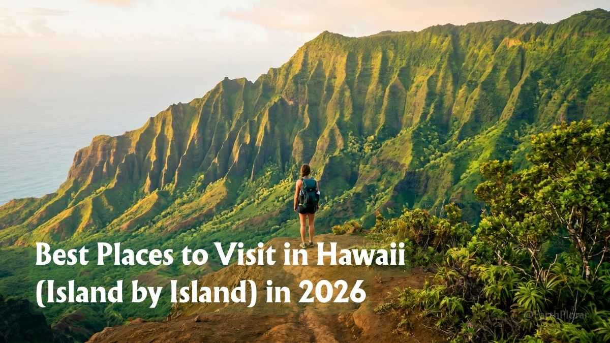 Hiker looking out over the Na Pali coast from a high vantage point, one of the Best Places to Visit in Hawaii