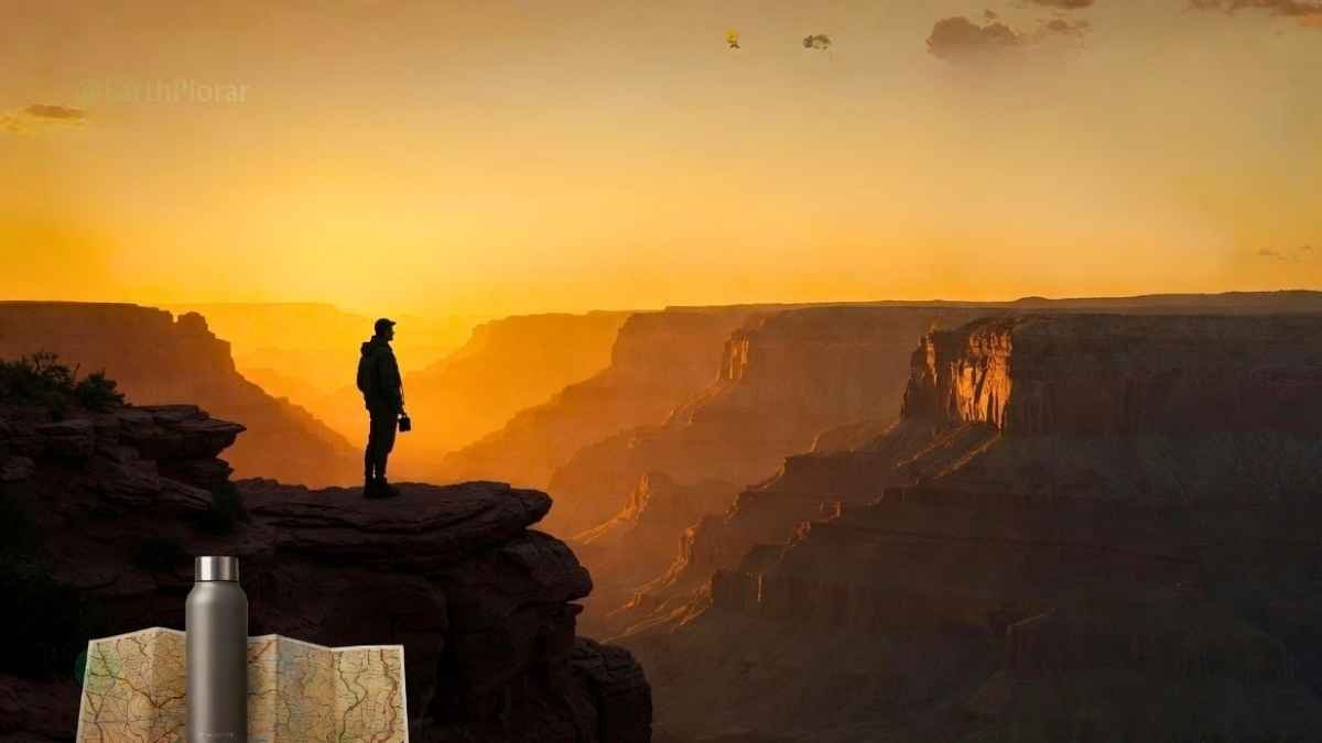 Explorer viewing Earth's Natural Wonders at sunrise with sustainable practices in a vast canyon landscape