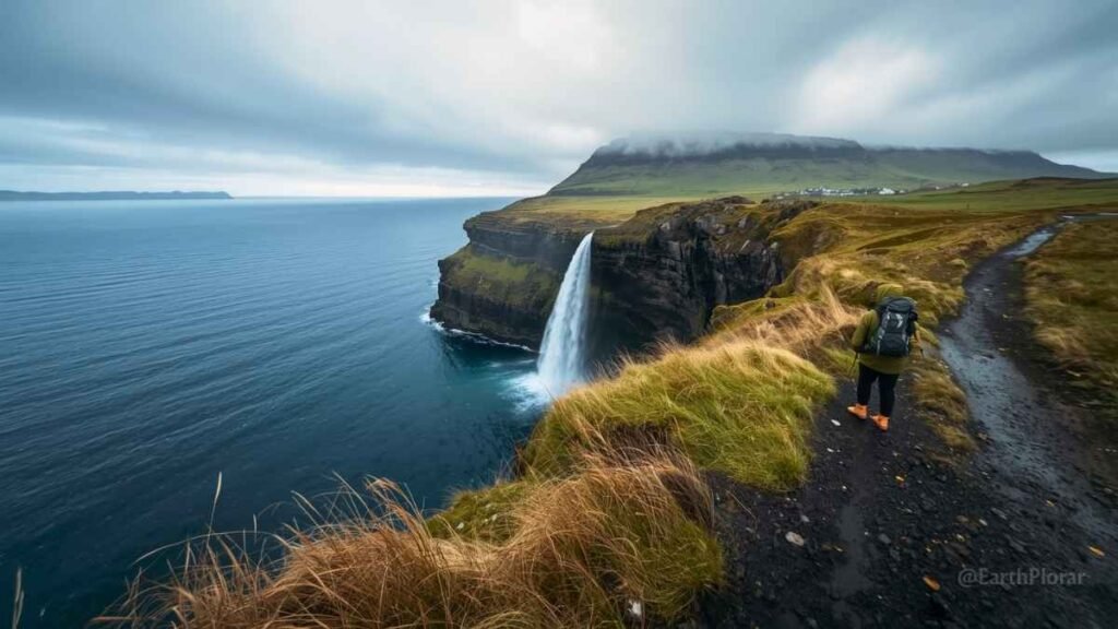 Faroe Islands Gásadalur waterfall coolcation destination 2026 – hiker on coastal cliffside trail