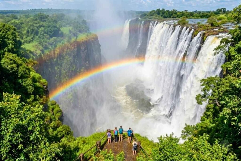Victoria Falls, one of the 7 natural wonders of the world, creating a vibrant rainbow in the mist.
