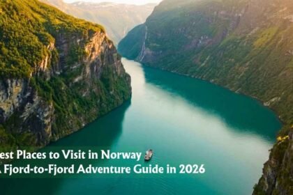 Aerial view of a narrow Norwegian fjord between steep green cliffs, one of the best places to visit in Norway