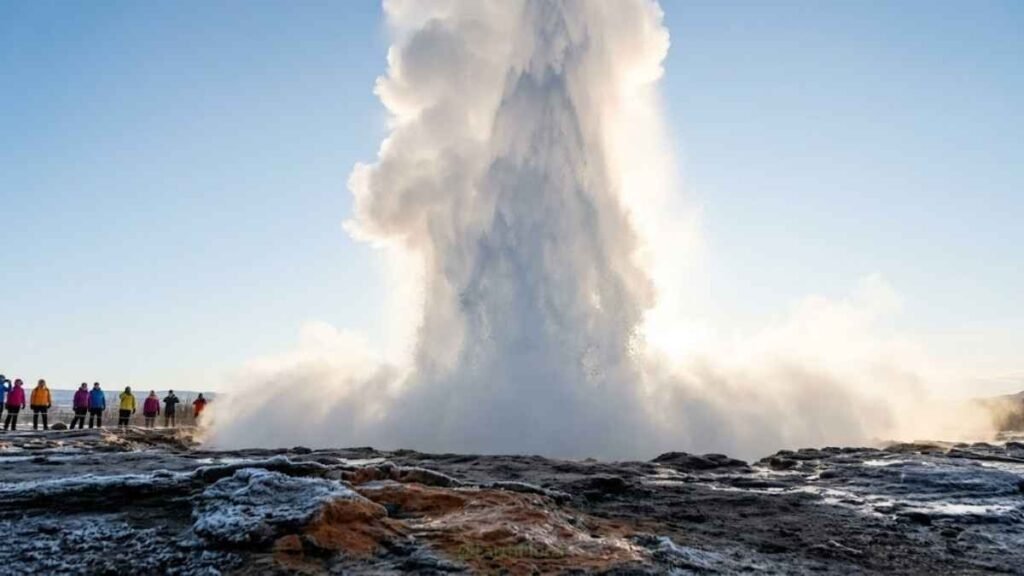 Strokkur geyser erupting 40 metres high on the Golden Circle, steam cloud backlit by Icelandic winter light, best places Iceland