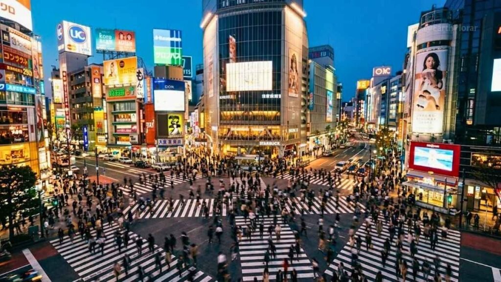 Aerial view of Shibuya Crossing at dusk with pedestrians crossing, Tokyo Japan urban adventure destination